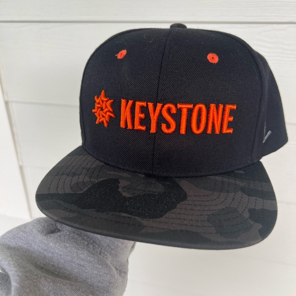 Ski Keystone 2024 SnapBack Flat Brim Hat orange and black Camo